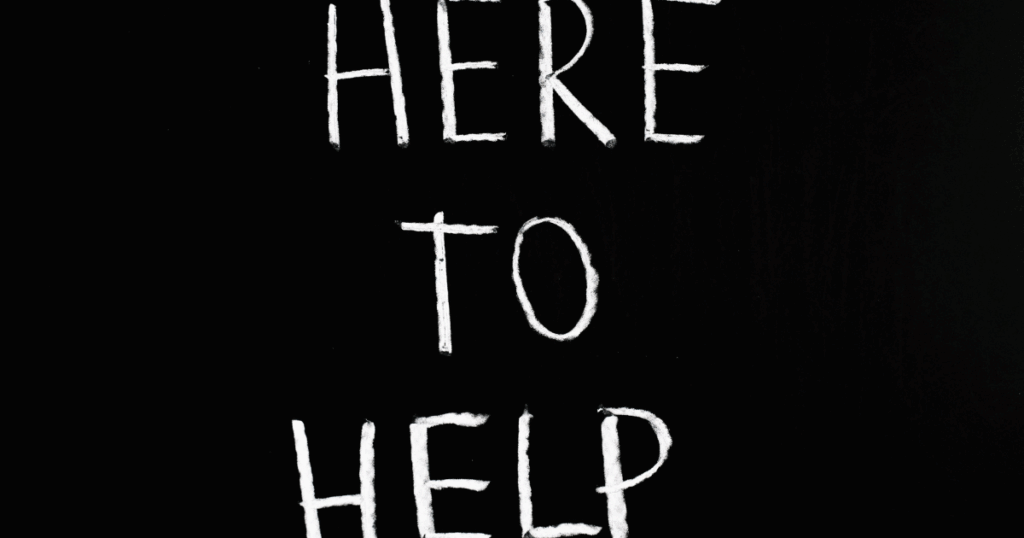image - Tennessee Behavioral Health Crystal Meth Addiction: "Here to Help" message in white chalk on black, offering substance abuse assistance.