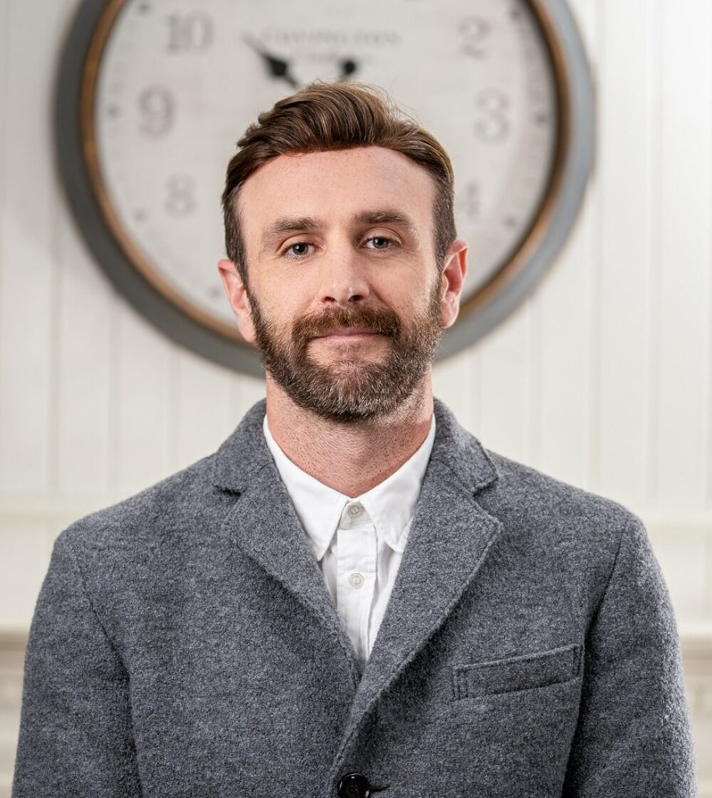 Nick Cies, Business Development Staff Member. Professional headshot of business man in gray jacket and white shirt.